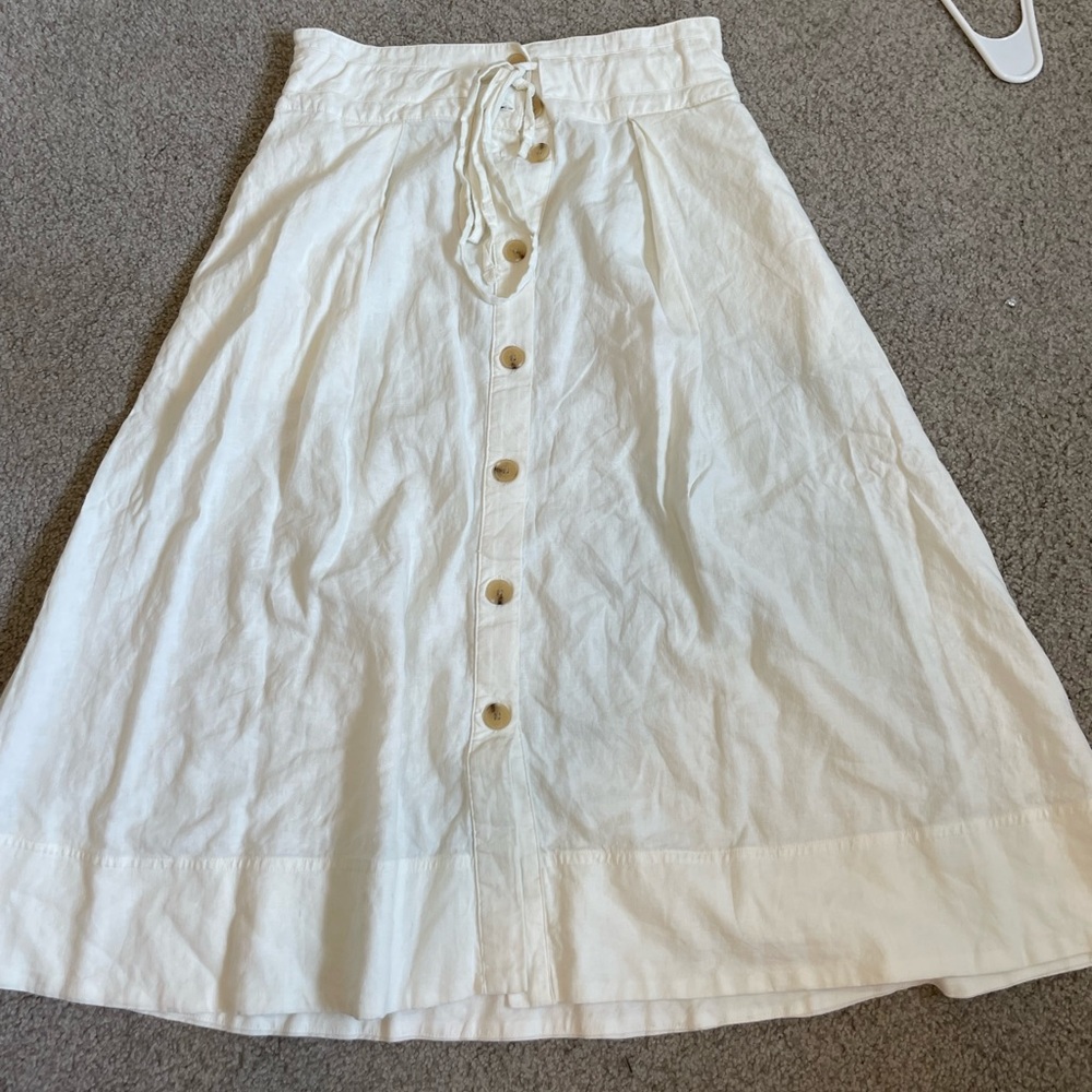White flowy skirt with tie and button details